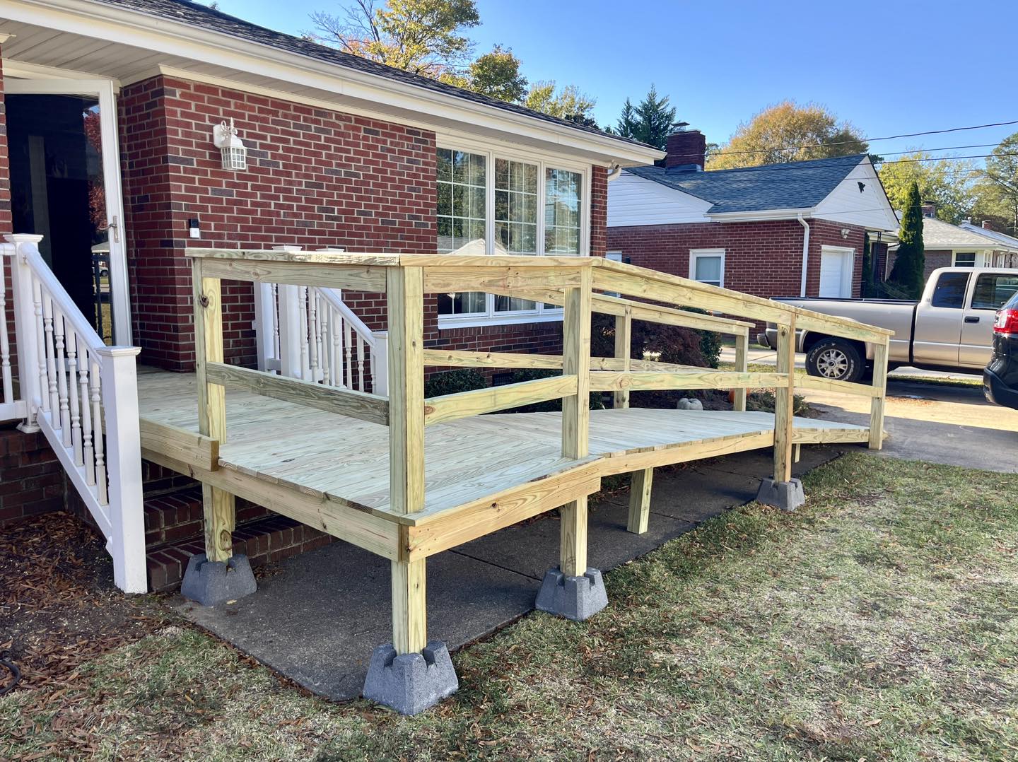 Wood deck with white railings built by Trinity Contracting — deck contractor Portsmouth VA Hampton Roads
